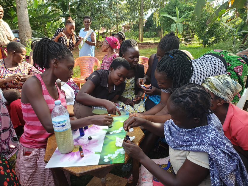women receiving training on how to make an insect repellant to prevent malaria.