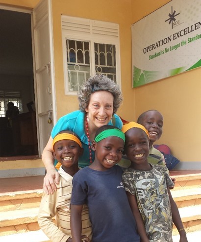 Picture of Rosie and 4 adorable kids around age 8 from Kampala Children's Center